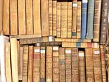 a box full of old books sitting on the floor