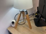 a desk with a lamp and a computer on it
