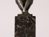 an image of a sculpture of a man sitting on top of a marble block