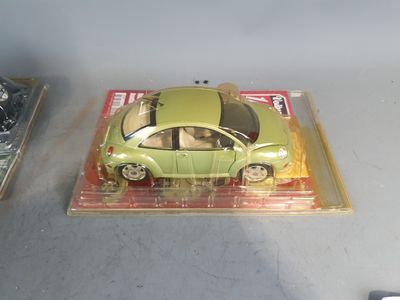 a green toy car sitting on top of a box