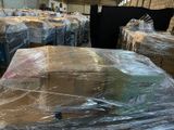 a large amount of boxes wrapped in plastic in a warehouse
