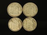 four british silver sovereigns, one of which has a picture of a man and a woman on it