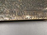 an image of a close up of a metal object on a table