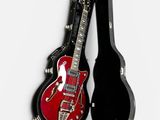 guitar case with a red electric guitar and a black electric guitar