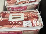 several bags of baby clothes sitting on a shelf in a store