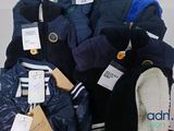 a pile of clothing that is on display in a store