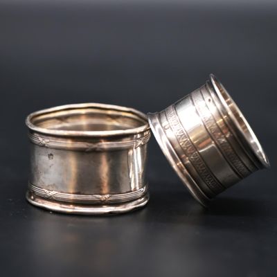 a silver cup sitting on a table next to a silver cup