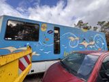 a blue and yellow trailer parked next to a red car