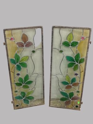 pair of stained glass panels with flowers and leaves on them