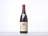 a bottle of red wine sitting on top of a table