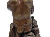 bronze statue of a boy with a dog on a marble base