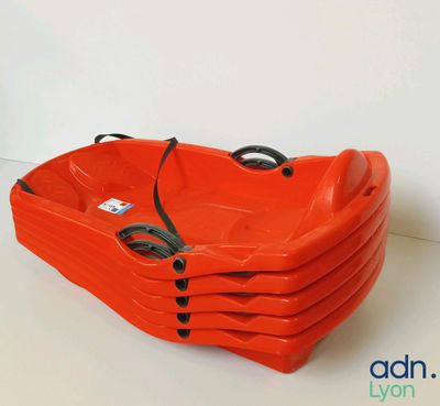 four orange plastic tubs stacked on top of each other