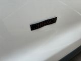 a sticker on the hood of a white car