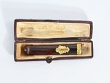 a pen that is in a case on a white surface