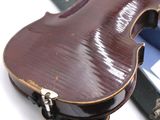 a violin sitting next to a case on a table