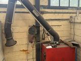 a large pipe sticking out of the wall of a building