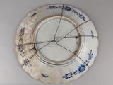 a blue and white plate with a clock on it