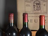 several bottles of wine are lined up on a shelf