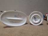 three porcelain dishes sitting next to each other on a table