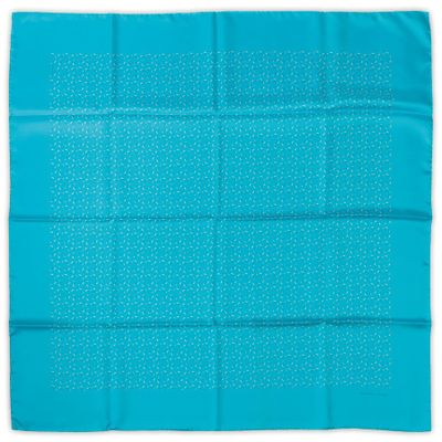a teal blue banda with white dots on it