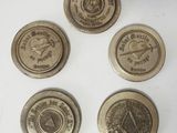 four antique brass buttons with the names of different countries on them