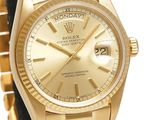 an image of a gold rolex watch with roman numerals