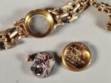a gold bracelet with a watch and a coin on it