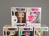 a bunch of pop vinyl figures in a display case