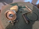 a pair of scissors and a spool on a table