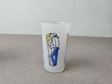 two shot glasses with cartoon characters on them sitting on a table
