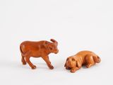 pair of wooden figurines of a bull and a dog