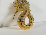 gold plated dragon brooch with diamond eyes and tail