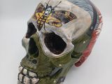 an image of a skull with a butterfly painted on it
