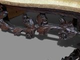 a wooden bench with a cushion on top of it