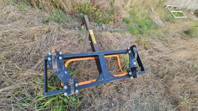 a blue and orange ladder that is laying in the grass
