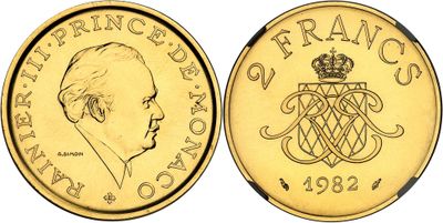 a close up of a gold coin with a crown on it