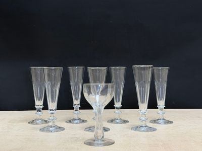 four empty wine glasses sitting on a table with a black background