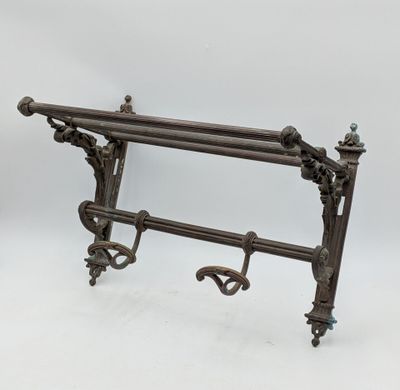 un porte-serviettes ancien en fonte, orné d'un motif décoratif