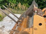 a bulldozer sitting in the middle of a field