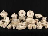 many different types of porcelain dishes and cups on a table