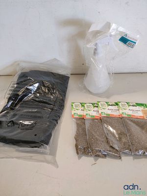 two bags of seeds and a bottle of water on the counter