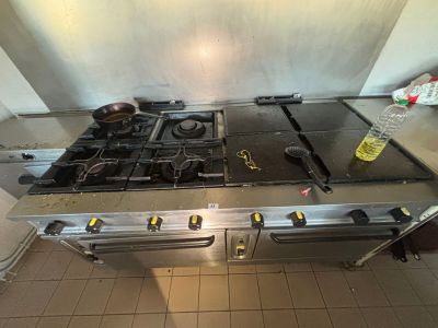a kitchen with a stove and a sink in it
