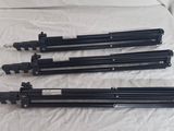 a group of four tripods sitting on top of a bed