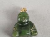 a small green figurine sitting on a white surface