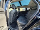 the back seats of a black car with the door open