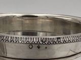 a silver plate with a design on it on a table