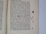 a book open on a white table with a butterfly on it