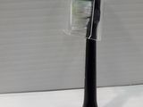 a plastic toothbrush holder with a toothbrush inside of it