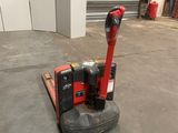 a red machine that is sitting on a pallet