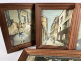 three framed paintings of a street scene with people walking down the street